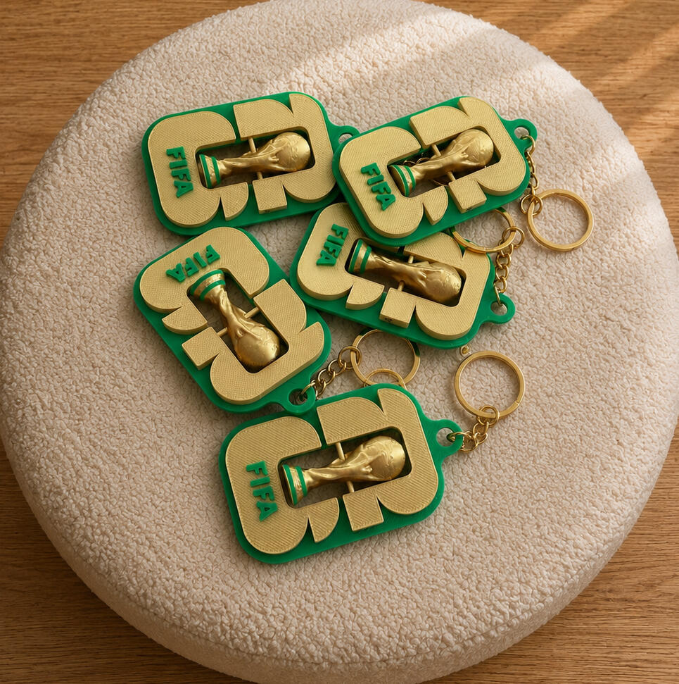 World Cup Inspired Keychains World Cup inspired trophy keychains displayed on a cream background.